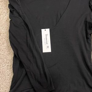 Plain black 3/4 long sleeve shirt with low back. Brand new with tag.